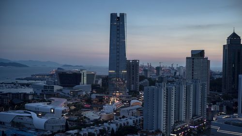 High angle view of city lit up against sky