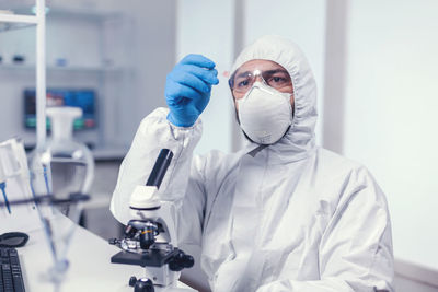 Portrait of scientist holding dentures