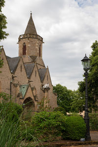 Church by building against sky