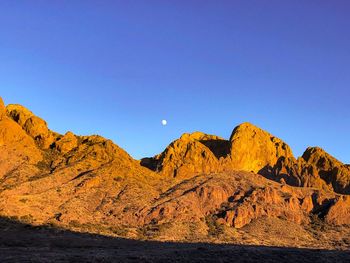 Scenic view of mountains against clear blue sky