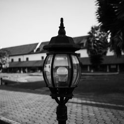Close-up of street light against building