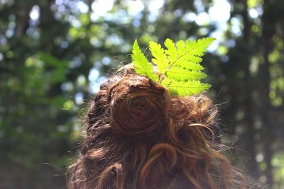 Portrait of woman with green leaves