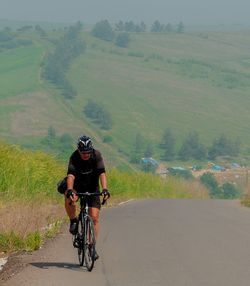 Man riding bicycle on road