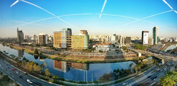 High angle view of illuminated cityscape against clear blue sky