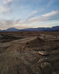 Scenic view of mountains against cloudy sky