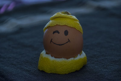 Close-up of golden face on table