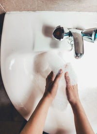 Midsection of man in bathtub