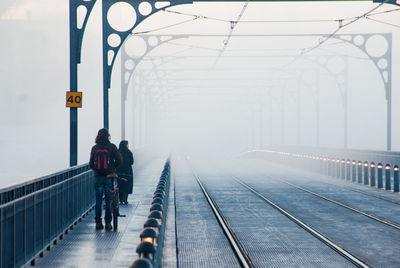 Rear view of people on railroad station platform