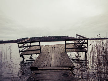 Pier over lake against sky