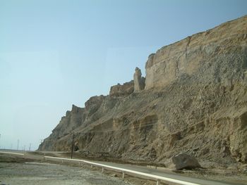 Road by mountain against clear sky