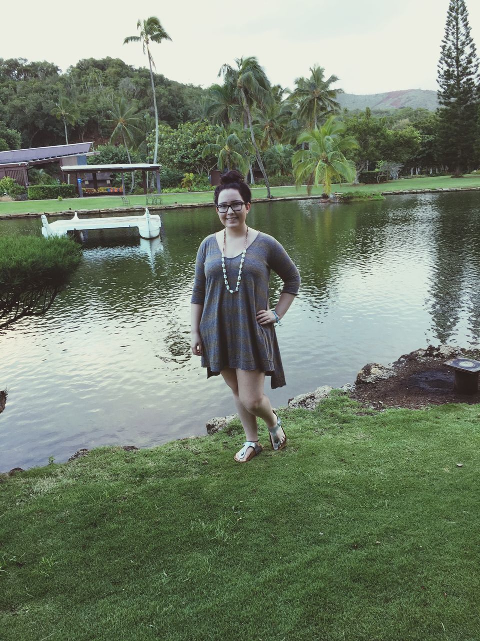 water, tree, lifestyles, person, full length, young adult, leisure activity, casual clothing, lake, young women, river, portrait, looking at camera, nature, standing, grass, front view, sitting