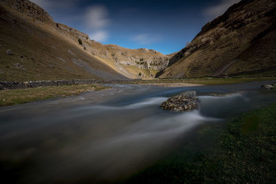 Scenic view of waterfall against sky