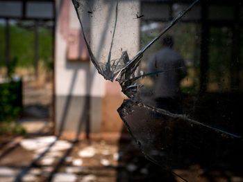 Close-up of rusty metal against building