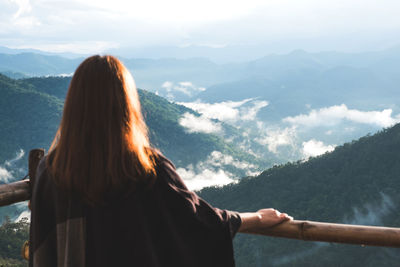 Rear view of woman looking at mountains