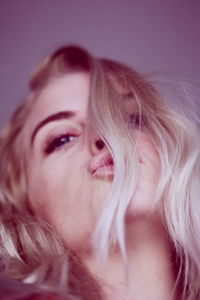 Close-up of young woman against white background