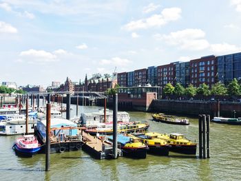 Boats in river with city in background
