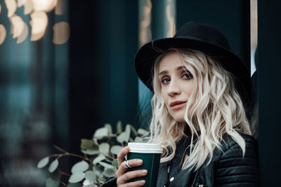 Portrait of young woman drinking water