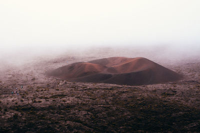 Scenic view of arid landscape against sky