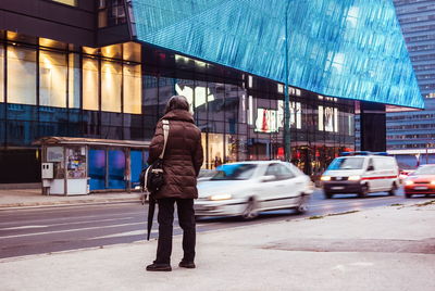 Full length rear view of man walking on street