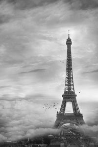 Silhouette of eiffel tower against cloudy sky