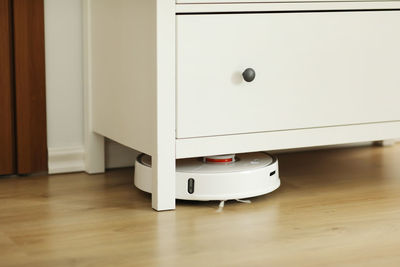 Close-up of suitcase on hardwood floor at home