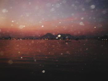 Scenic view of river against sky at night