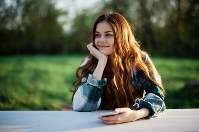 Young woman sitting on field