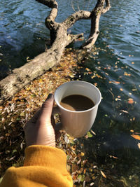 Midsection of person holding coffee cup