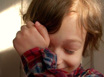 Close-up portrait of cute girl at home