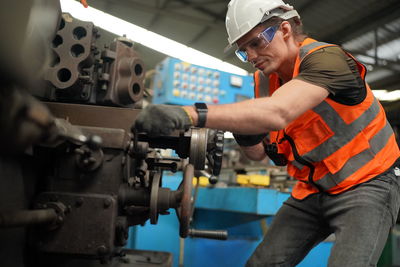 Portrait of male worker standing in the heavy industry manufacturing factory.