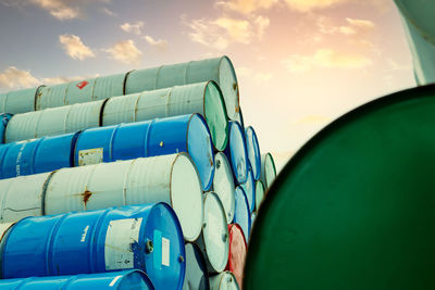 Old chemical barrels stack. red, green, and blue chemical drum. steel tank of flammable liquid. 