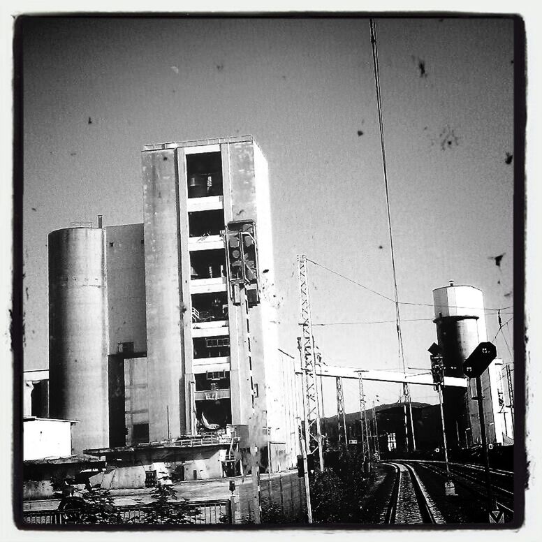 transfer print, auto post production filter, building exterior, built structure, architecture, transportation, mode of transport, low angle view, land vehicle, day, building, metal, construction site, abandoned, outdoors, no people, obsolete, industry, sky, old