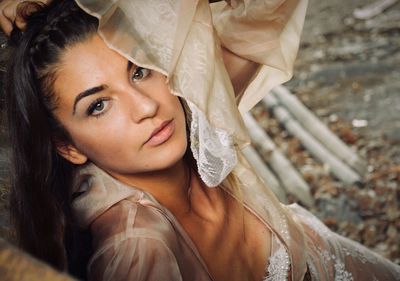 Portrait of beautiful woman sitting on field