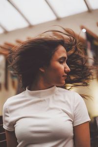 Young woman with eyes closed tossing hair