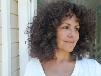 Smiling woman with curly hair outdoors