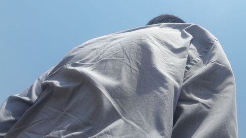 Rear view of people against clear blue sky