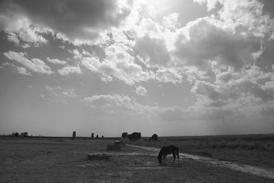 Scenic view of landscape against cloudy sky