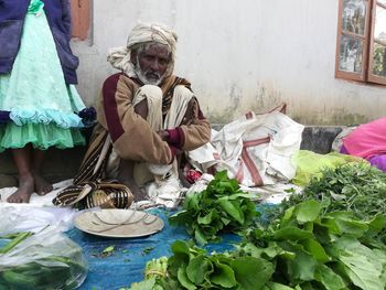 Midsection of woman sitting at market