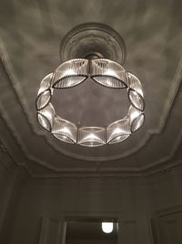 Low angle view of illuminated pendant lights hanging from ceiling