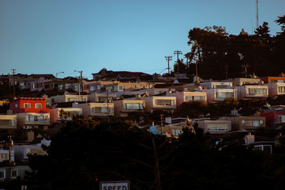 Buildings in city against clear sky