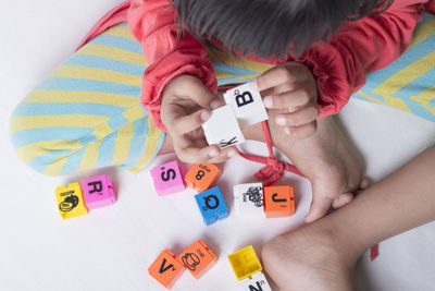 High angle view of child playing with toy at home