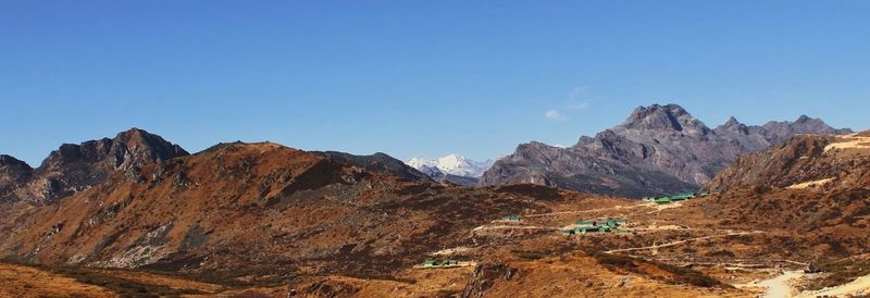 Panoramic alpine landscape and snowcapped himalaya mountains near bum la pass in tawang, india