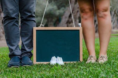 Low section of woman standing on grass