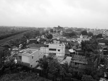 High angle view of houses in town against sky