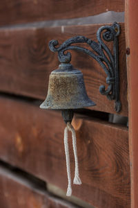 Close-up of old rusty metal hanging against wall