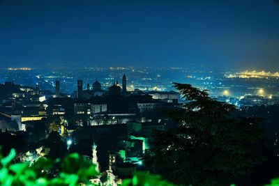 High angle view of illuminated buildings in city at night