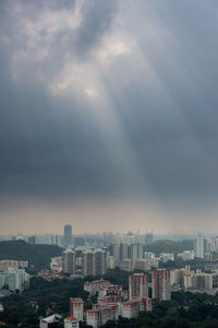 View of cityscape against cloudy sky