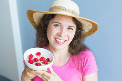 Portrait of smiling young woman holding ice cream