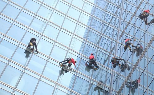 Low angle view of window cleaners