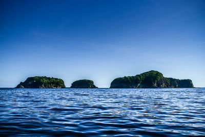 Scenic view of sea against clear blue sky